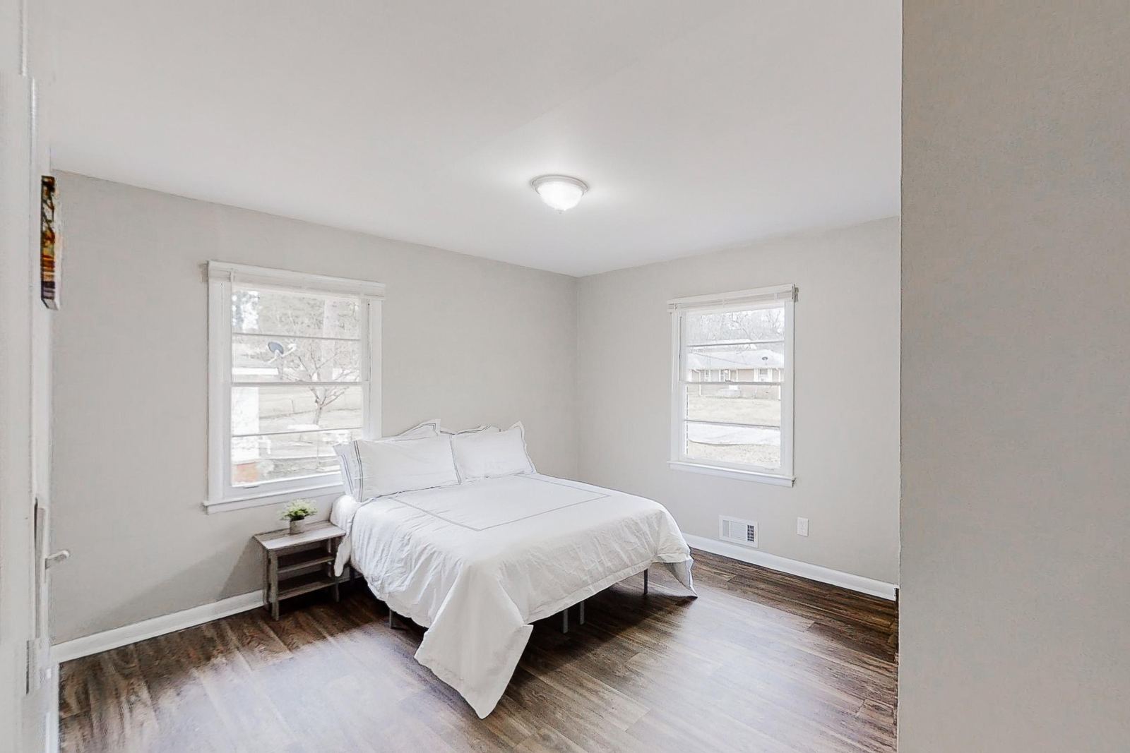 Furnished bedroom with double windows