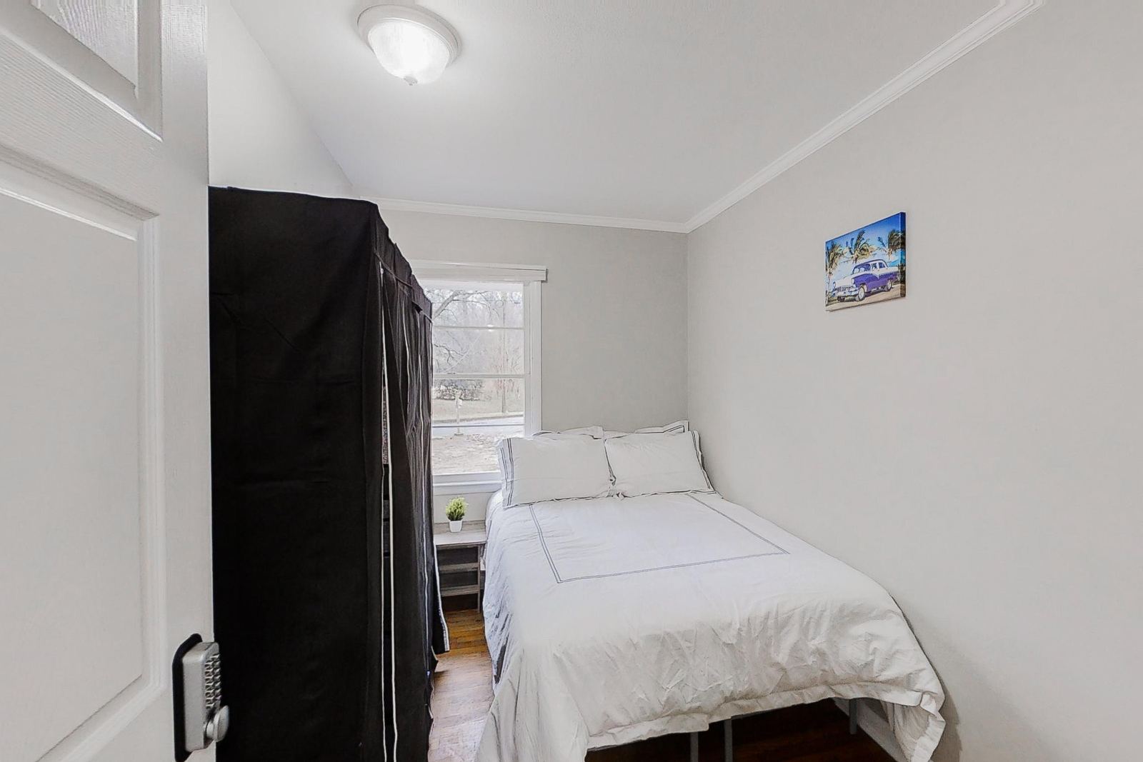 Furnished bedroom with wardrobe